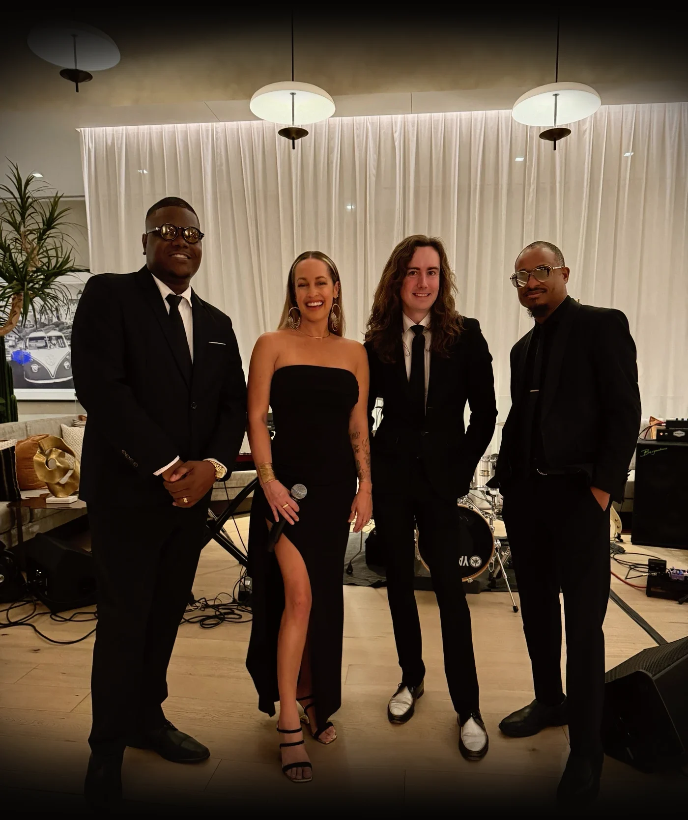 Blame Us! band portrait: Terry Harris Jr., Tiffany Dunn, Dylan Thomas and Buddy Banks in black suits and a black gown
